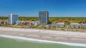 A coastal cityscape with a beach, high-rise buildings, and lush greenery. - Ocean Forest Plaza 708 - Oceanfront (Myrtle Beach)