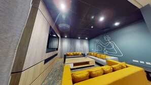 A modern living room with a sofa set, a coffee table, and a wall mural. - Student Only Will Wyatt Court (London)