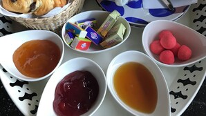 A breakfast tray with croissants, juice, and various condiments. - A bed and breakfast in the woods (Pommiers)