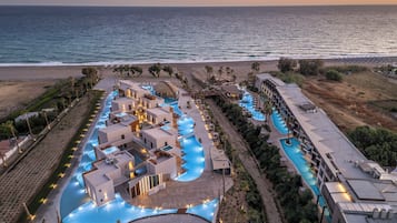 A resort with multiple swimming pools, beachfront access, and a view of the ocean.