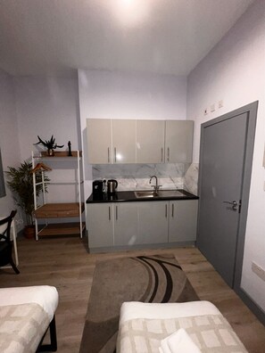 Economy Triple Room | Private kitchen | Mini-fridge, microwave