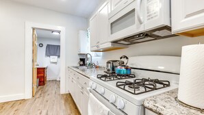 A kitchen with white cabinets, a stove, and a microwave. - 1 Mi to Dtwn: Pet-friendly Corning Retreat (Corning)