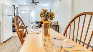 A dining area with a wooden table, chairs, and a vase with flowers. - 1 Mi to Dtwn: Pet-friendly Corning Retreat (Corning)