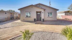 A single-story house with a front door, two windows, and a small porch area. - 3 Mi to Tucson Mall: Home w/ Large Outdoor Space! (Tucson)