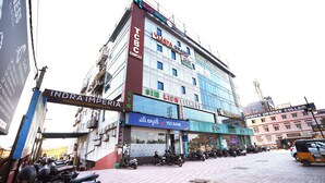 A multi-story building with various commercial establishments including a gym, bank, and educational institutions. - Melody mings (Hyderabad)