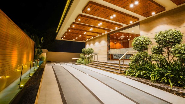 A modern building with a wooden ceiling, outdoor stairs, and a glass railing. - VS Imperial (Akola)