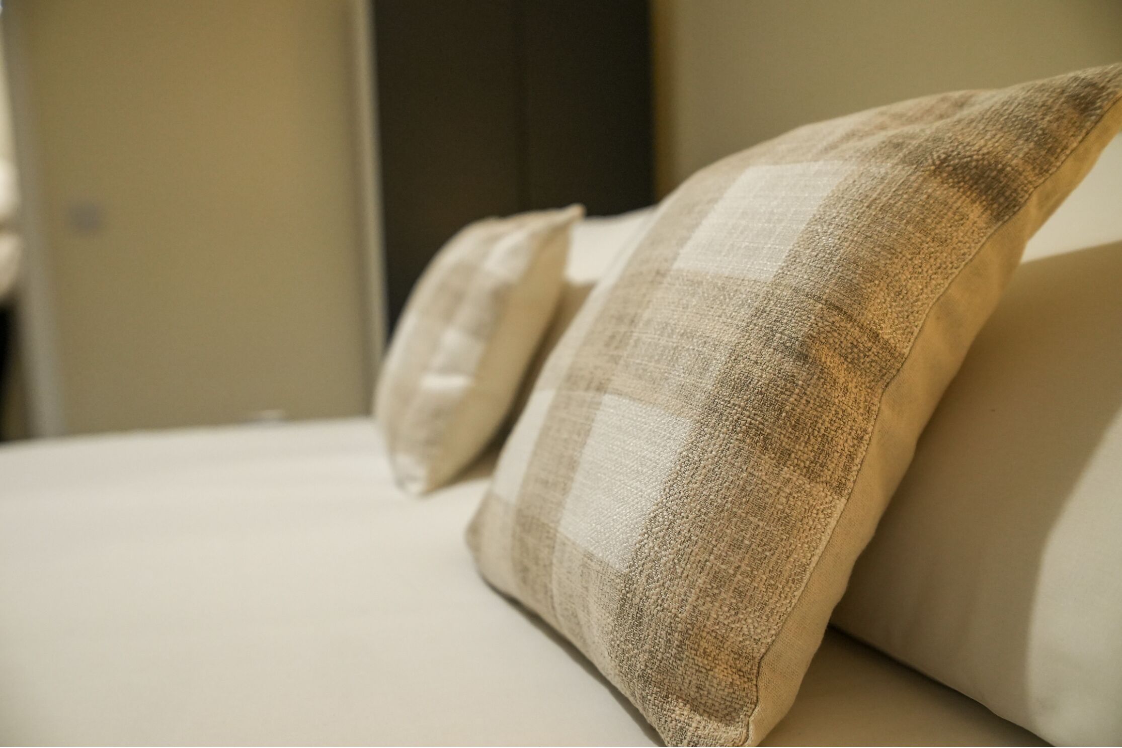 A close-up of a bed with two pillows and a neatly made bedspread.