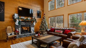 A cozy living room with a fireplace, a Christmas tree, and a comfortable seating area. - Comfort and Luxury at its best, Hot Tub 1 Dog. New Property (Blairsville)