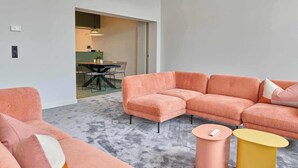 A modern living room with a sectional sofa, a coffee table, and a small side table. - Luxurious townhouse in AAA location with nearby parking. (Brugge)
