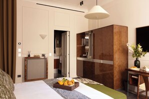 A hotel room with a bed, breakfast tray, a desk with a vase, and a view of the bathroom. - Palais Bourbon Hotel - Room 42 - 2P - Invalides (Paris)