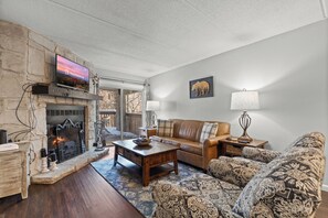 Signature Condo, 2 Bedrooms, Fireplace, Mountainside | Living room | 49-inch Smart TV with cable channels, fireplace - Hilltop Paradise (Gatlinburg)