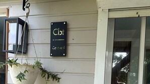 A building exterior with a hanging sign reading "Cbt" and "Coresol". - Le Corossol (Fort-de-France)