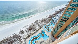 A resort with a beach view, a pool area, and a high-rise building. - Newest Beachfront Complex!!  Professionally Decorated 4BR!!  Lazy River!! (Orange Beach)
