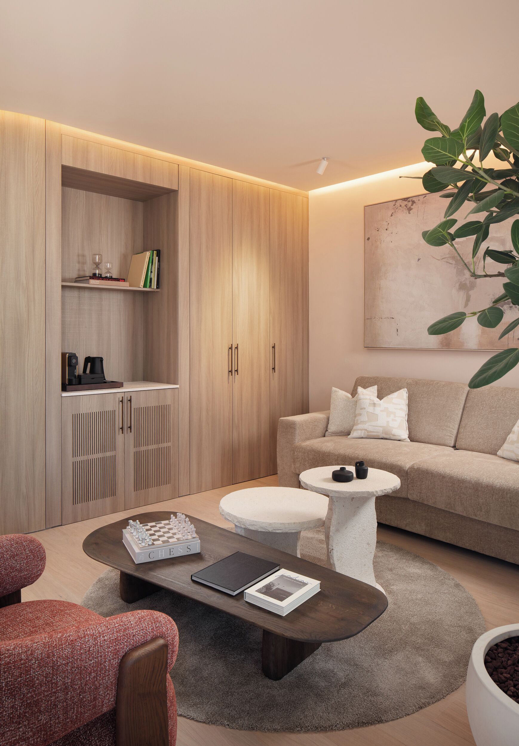 A modern living room with a sofa, coffee table, and a bookshelf.