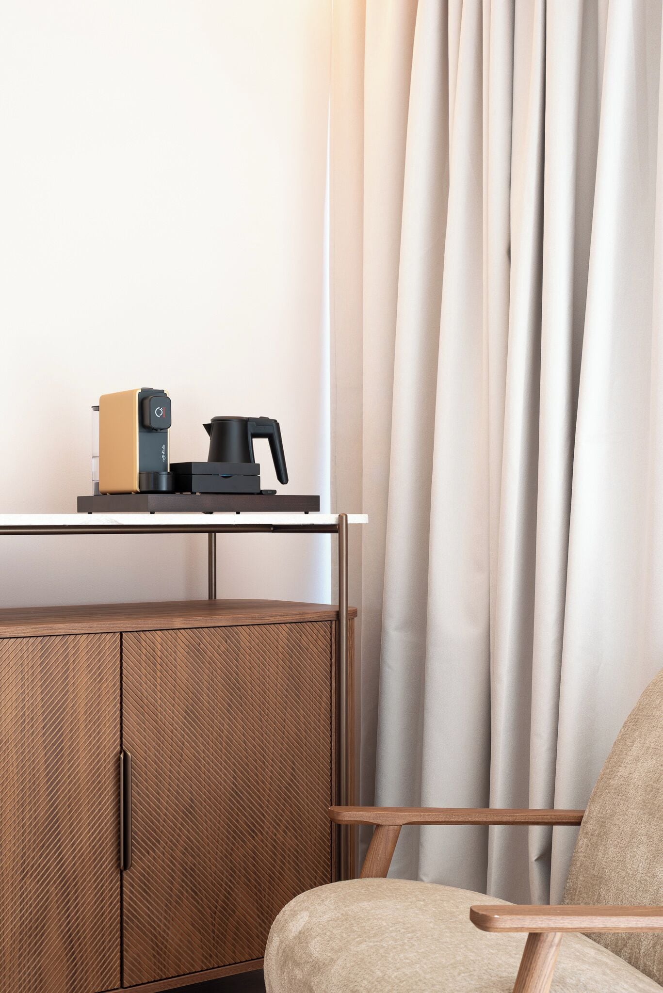 A modern room with a wooden cabinet, a small table with a coffee maker, and a chair.