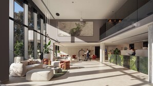 A spacious lobby with large windows, a reception desk, and modern seating areas. - Hotel Sumratin (Dubrovnik)
