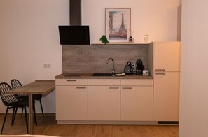 Fridge, coffee/tea maker, electric kettle, cookware/dishes/utensils