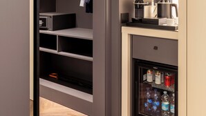 A modern kitchen with a built-in refrigerator, a coffee machine, and a microwave. - LUMERA STAY - Brera (Milan)
