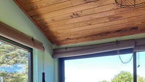 A bar area with a view of a lake and forest, wooden ceiling, and a window with blinds. - House overlooking private lake in mid-mountain setting. Peace and quiet in the heart of nature! (Pradelles-Cabardès)