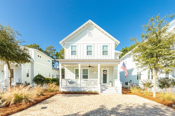 Charming beach house with a welcoming front porch—perfect for morning coffee or evening breezes