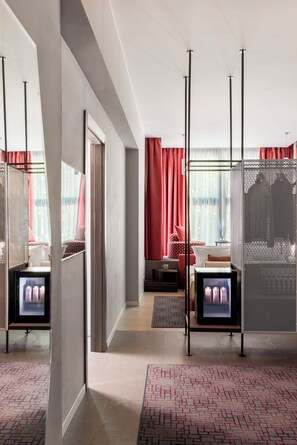 A modern hotel room with a large bed, a seating area, and a TV. - PARIOLI CUBE HOTEL (Rome)