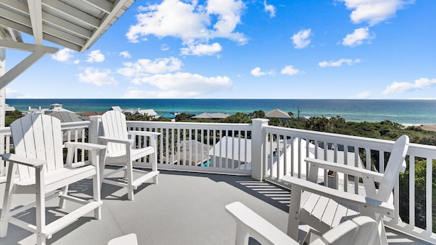 A covered outdoor area with white Adirondack chairs and a view of the ocean. - 🌴Almost Heaven • Gulf View Luxury with Private Heated Pool & Deeded Beach Access (Santa Rosa Beach)