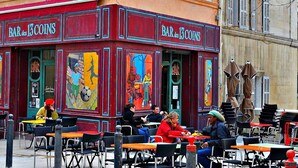 Eine farbenfrohe Bar mit Außenbereich, Wandmalereien und einer Statue.