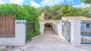 A gated entrance with a sign reading "ABETO," leading to a building with a tiled roof and a stone pathway. - Villa Abeto - Two Bedroom Villa, Sleeps 4 (El Tosalet)
