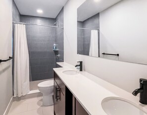 Shower, hair dryer, towels, toilet paper