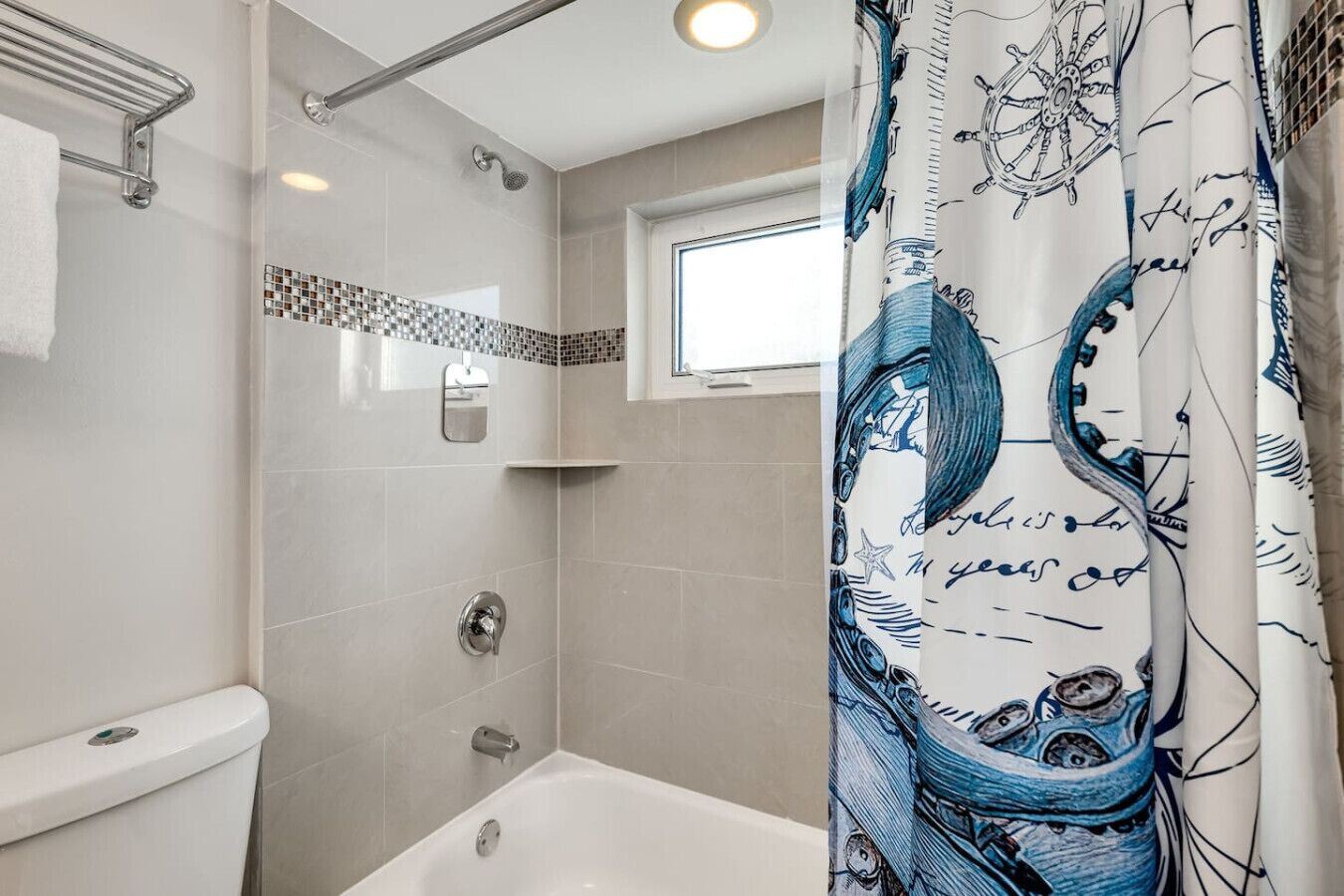 A bathroom with a shower, a toilet, and a bathtub.