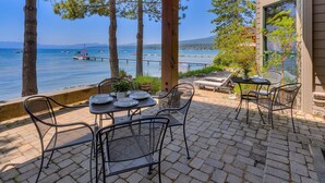 Un patio con mobiliario exterior y vista al mar.