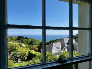 A window view of a coastal area with houses and greenery. - Beulah, stunning sea views (Dartmouth)