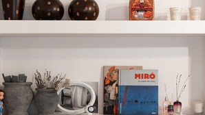 Three shelves with decorative items, including vases, books, and a mirror. - 2BR Greek Home | Private Backyard 20' to Acropolis (Athens)