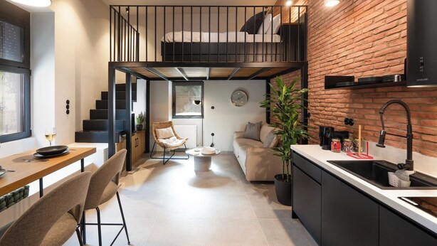 A modern loft-style apartment with a kitchen, dining area, and a loft bedroom with a balcony. - 1BR Boutique Apt Acropolis Rooftop view (Athens)