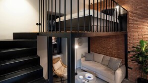 A loft-style bedroom with a bunk bed, a staircase, a sofa, and a coffee table. - 1BR Boutique Apt Acropolis Rooftop view (Athens)