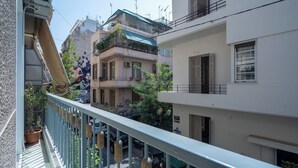 A multi-story building with balconies, a gated entrance, and a street view. - Urban Escape: Exarcheia Remodel (Athens)
