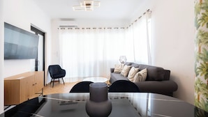 A modern living room with a glass table, a grey sofa, and a black chair. - Prime central location Athens, Big Balcony (Athens)
