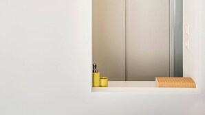 A minimalist room with a large mirror, a circular light fixture, and a wardrobe. - Athens' Best Location! ~Stunning & Spacious Studio (Athens)