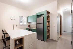 Enjoy cooking in this kitchen with a sink, compact stove, and refrigerator.