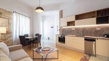 A modern kitchen with a marble countertop, stainless steel appliances, and a built-in dishwasher.