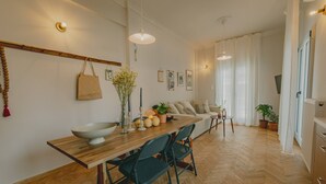Una cocina moderna con una mesa de madera, sillas y una cesta colgante.