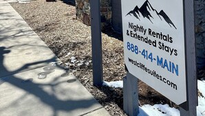 A sign for Westcliffe Suites advertising nightly rentals and extended stays.