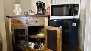 A compact kitchen with a microwave, coffee maker, and a small refrigerator. - King Mountain Suite (Westcliffe)