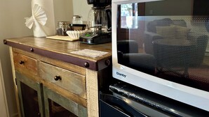A kitchen counter with a coffee maker, a microwave, and a paper towel holder. - King Mountain Suite (Westcliffe)
