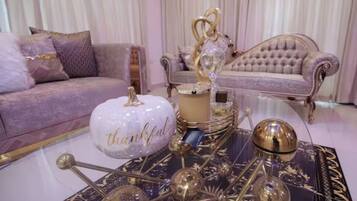 A luxurious living room with a plush sofa, a decorative coffee table, and elegant decor.