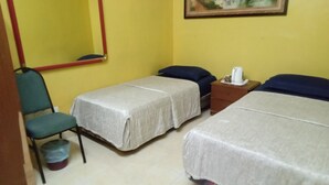 A room with two beds, a chair, a small table with a kettle, and a trash bin. - Al Funduq Motel 1 (Jitra)