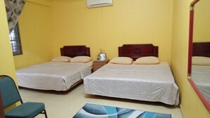 A room with two beds, a small table with a kettle, and a chair. - Al Funduq Motel 1 (Jitra)
