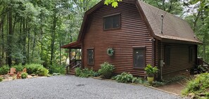 A rustic wooden cabin surrounded by dense forest. - Appalachian Cabin.North Georgia mountains-Firepit and Hot Tub with great views! (Ellijay)