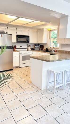 Fridge, microwave, oven, stovetop - Charming 4-bedroom home with plenty of off-street parking and beautiful views. (Page)