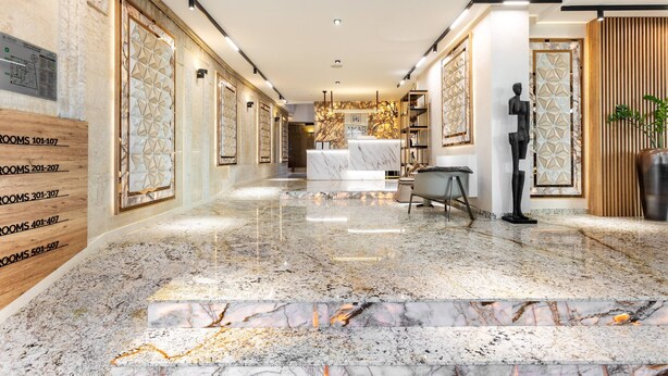 A hotel lobby with a marble floor, wooden paneling, and a reception desk. - AMAR Design Hotel by HMG (Sofia)